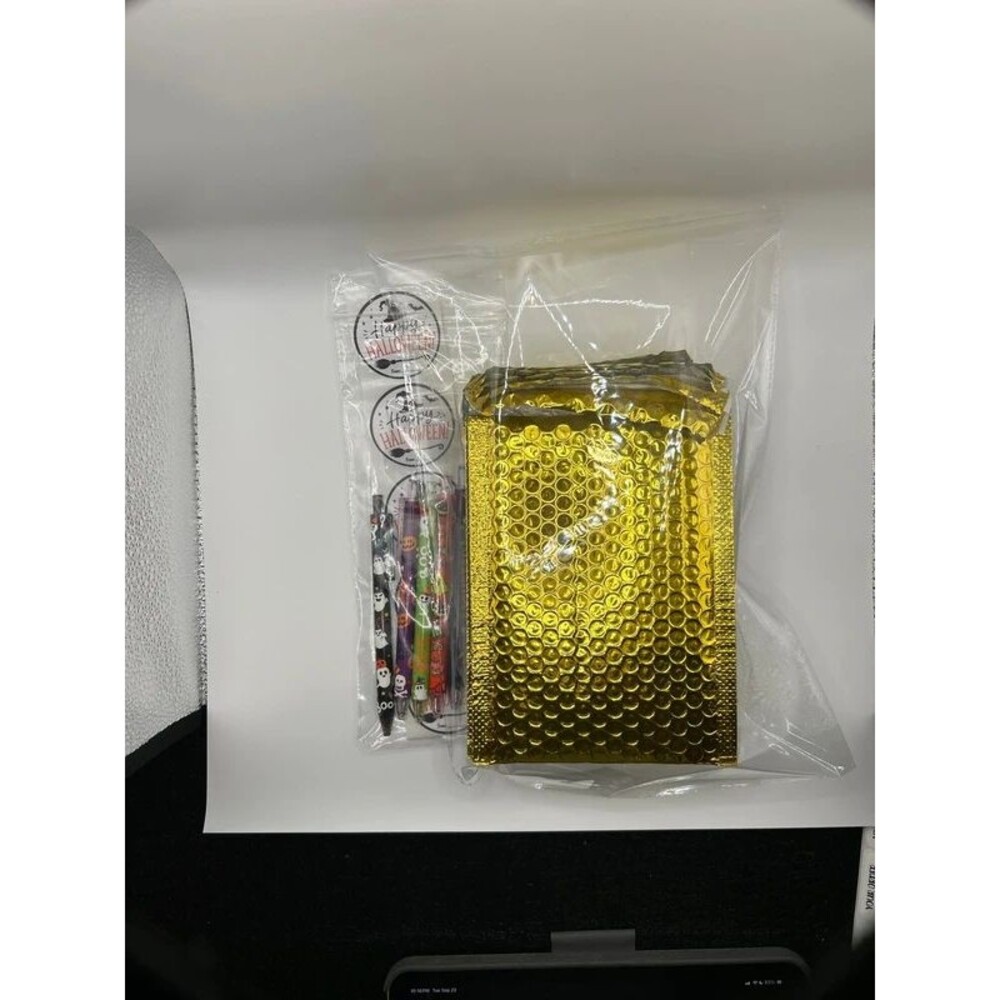 10 pack gold metallic bubble mailers and Halloween stickers and pens.